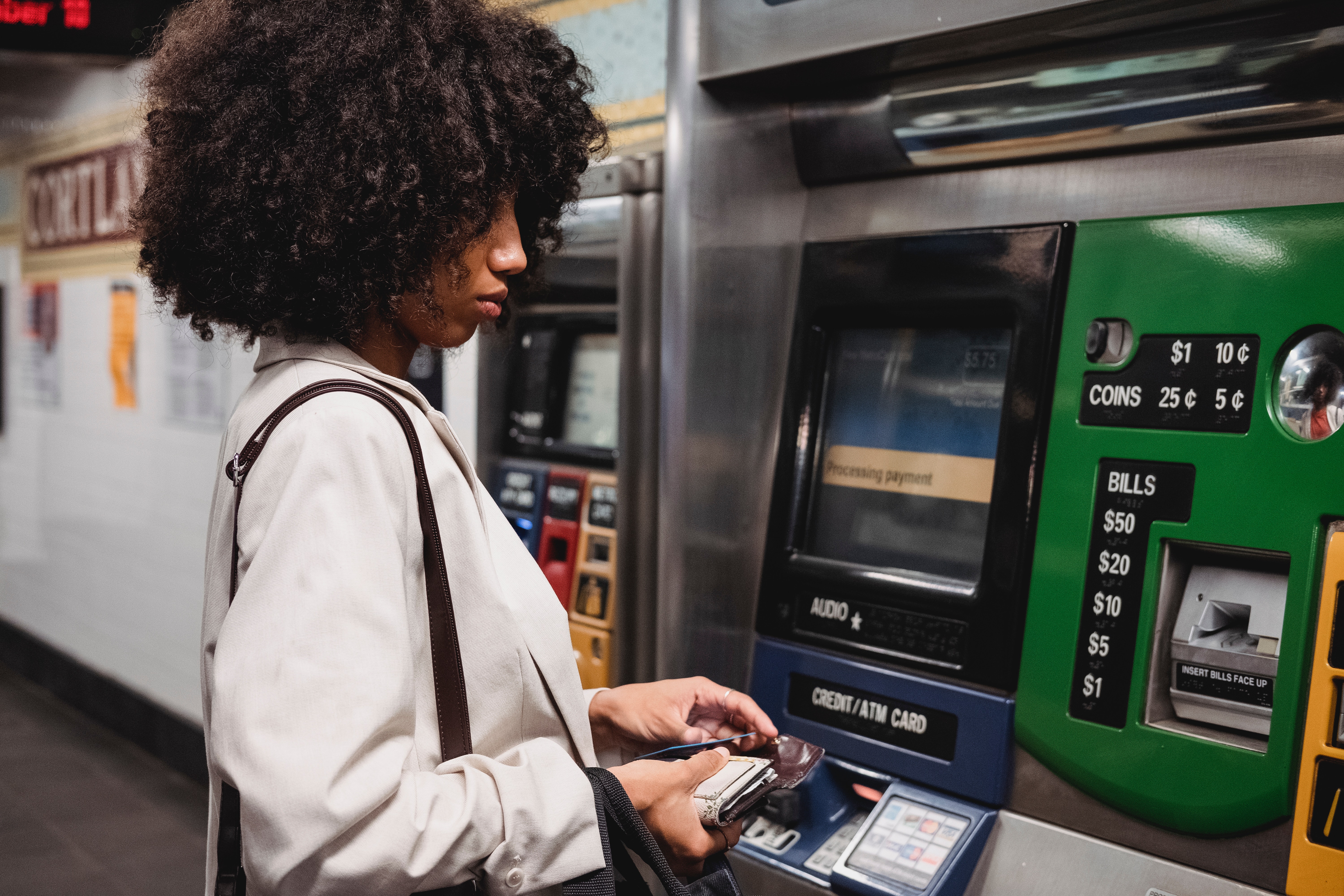 A woman in front of a ATM.